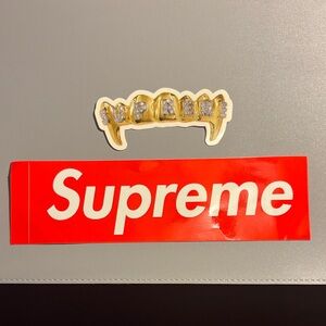 Supreme Red Sticker with Gold and Silver Grillz